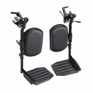 The image shows a pair of black, adjustable, detachable elevating leg rests for a wheelchair. The leg rests feature padded calf supports and footplates with a ribbed design.