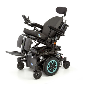 A black power wheelchair with aqua accents on the wheels. It features a padded seat, headrest, and leg supports, and comes equipped with various controls and adjustments, including tilt and recline capabilities. The chair is on a sturdy frame with six wheels.