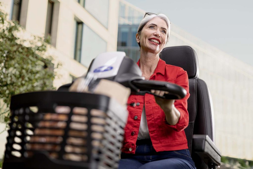 A elderly lady driving on an ORION METRO