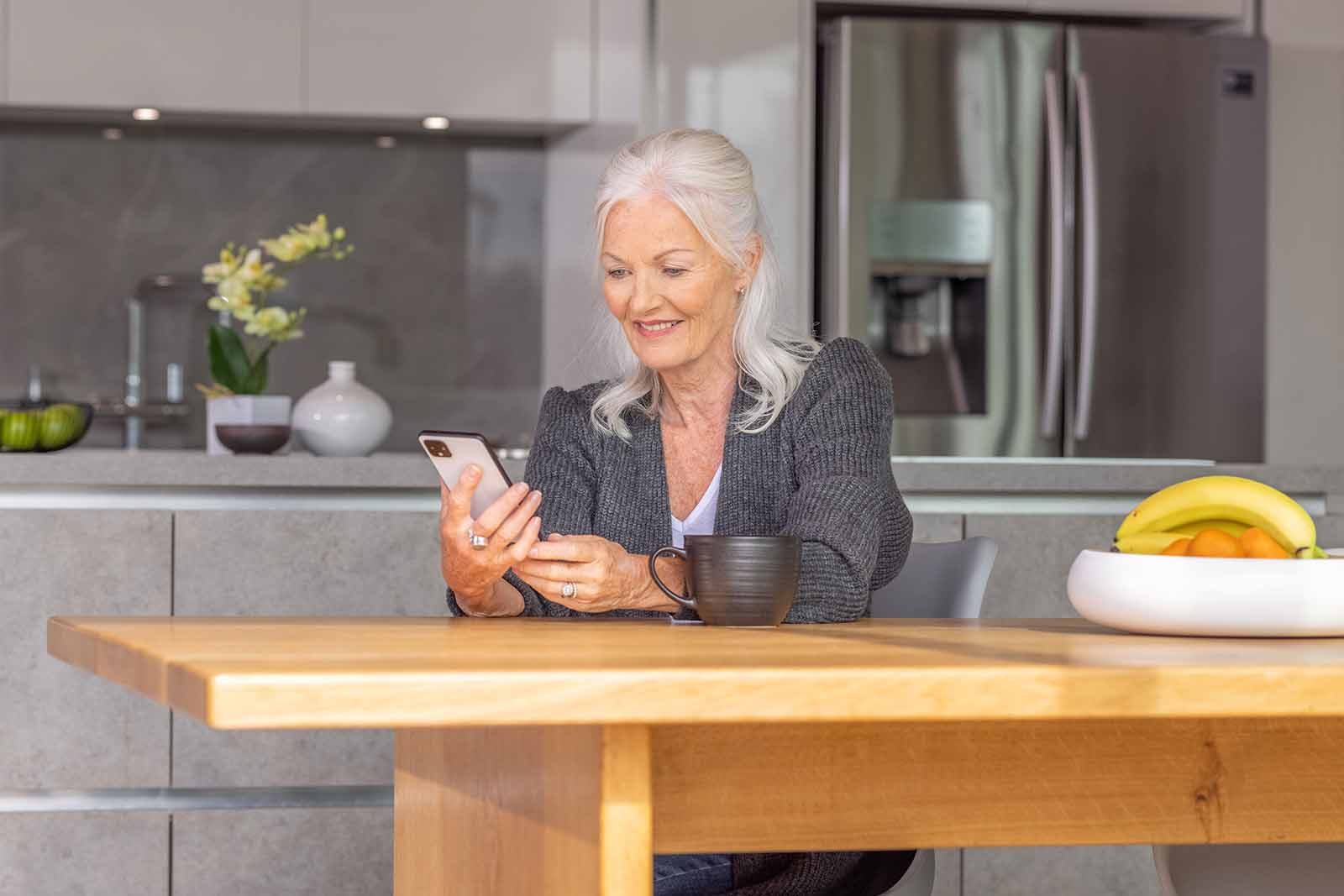 Woman using Invacare resource hub one mobile in kitchen